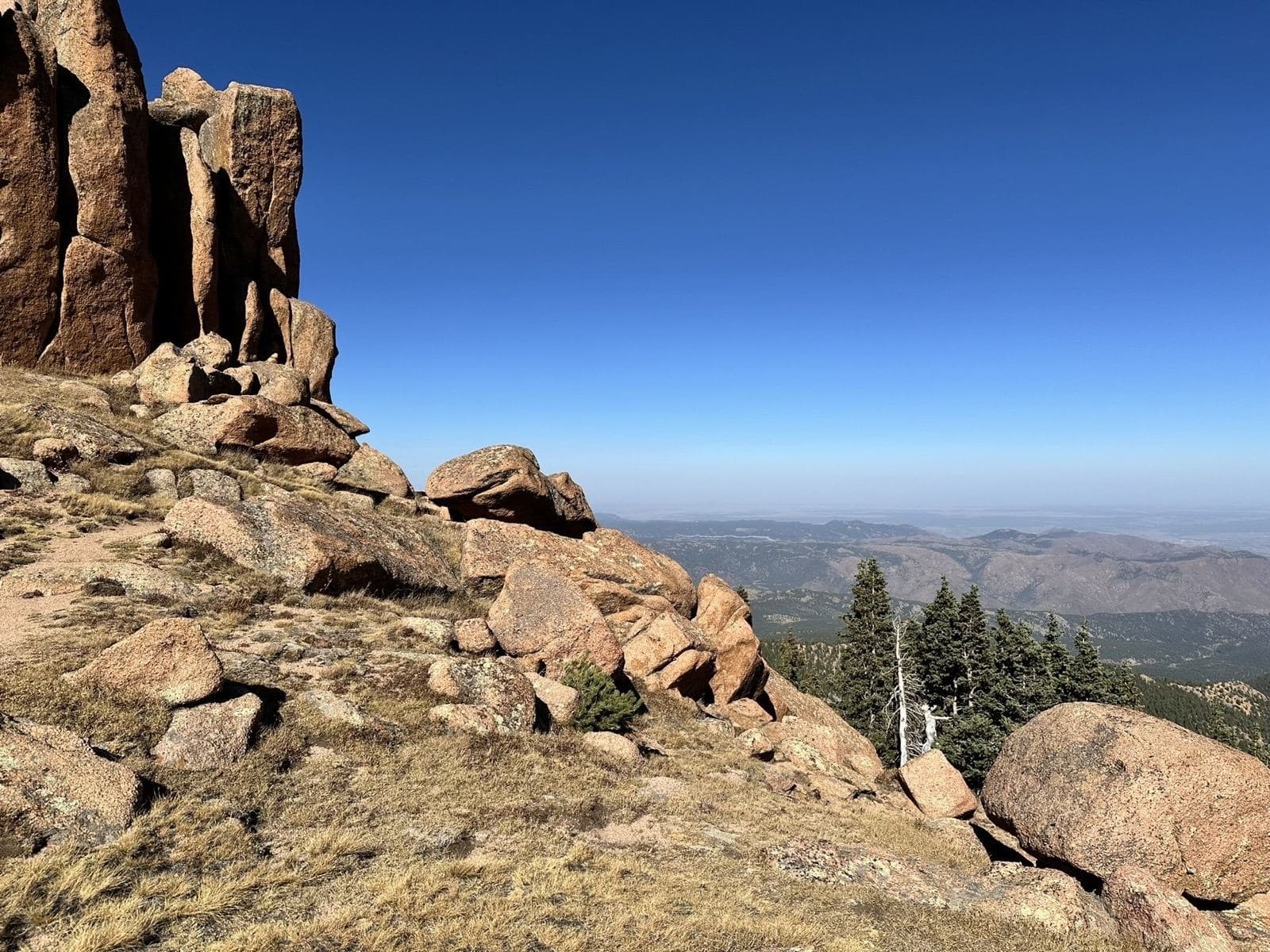 Granite boulders on a mountain summit overlooking a wide valley